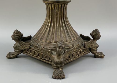 fig 11. A Renaissance Revival faience vase featuring blue and yellow glazed classical medallion artwork mounted on a cast bronze footed base with mask handles.