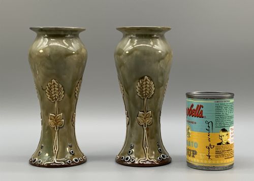 fig 2. A matched pair of Royal Doulton Lambeth Art Nouveau stoneware vases featuring raised relief botanical motifs on a muted olive green glazed ground.