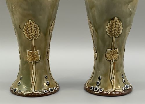 fig 5. A matched pair of Royal Doulton Lambeth Art Nouveau stoneware vases featuring raised relief botanical motifs on a muted olive green glazed ground.