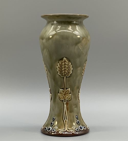 fig 6. A matched pair of Royal Doulton Lambeth Art Nouveau stoneware vases featuring raised relief botanical motifs on a muted olive green glazed ground.