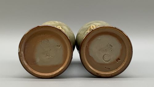 fig 8. A matched pair of Royal Doulton Lambeth Art Nouveau stoneware vases featuring raised relief botanical motifs on a muted olive green glazed ground.