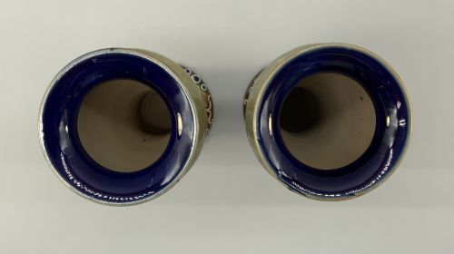 fig 10. A matched pair of Royal Doulton Lambeth Art Nouveau stoneware vases featuring raised relief botanical motifs on a muted olive green glazed ground.