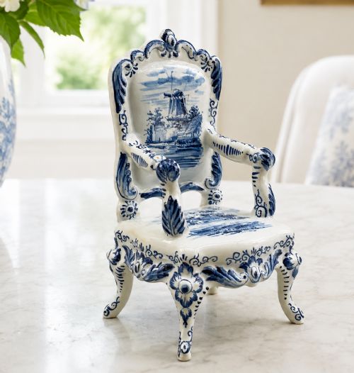 fig 1. A late 19th-century miniature porcelain armchair glazed in white and hand-painted with blue Dutch landscape scenes featuring a windmill.
