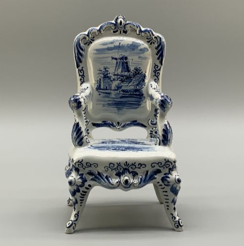 fig 3. A late 19th-century miniature porcelain armchair glazed in white and hand-painted with blue Dutch landscape scenes featuring a windmill.