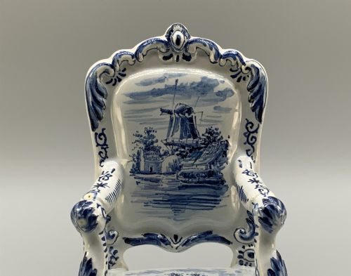 fig 4. A late 19th-century miniature porcelain armchair glazed in white and hand-painted with blue Dutch landscape scenes featuring a windmill.
