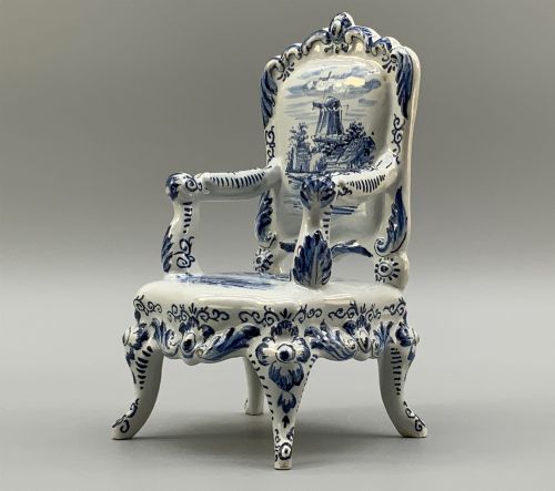 fig 5. A late 19th-century miniature porcelain armchair glazed in white and hand-painted with blue Dutch landscape scenes featuring a windmill.