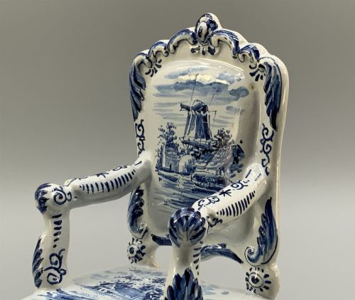 fig 6. A late 19th-century miniature porcelain armchair glazed in white and hand-painted with blue Dutch landscape scenes featuring a windmill.