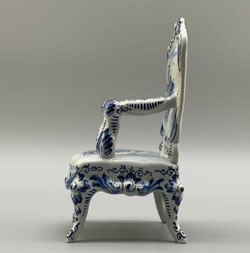 fig 7. A late 19th-century miniature porcelain armchair glazed in white and hand-painted with blue Dutch landscape scenes featuring a windmill.