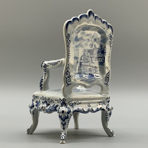 fig 8. A late 19th-century miniature porcelain armchair glazed in white and hand-painted with blue Dutch landscape scenes featuring a windmill.