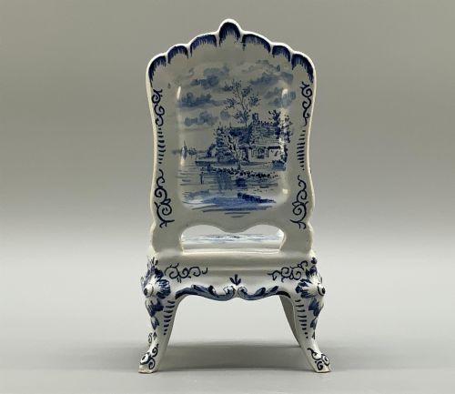 fig 9. A late 19th-century miniature porcelain armchair glazed in white and hand-painted with blue Dutch landscape scenes featuring a windmill.