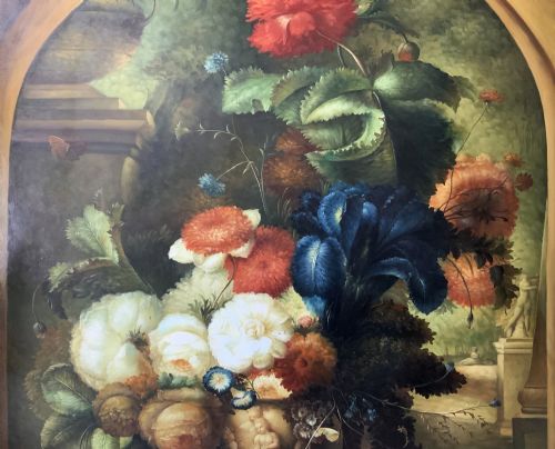 fig 4. A monumental oil painting depicting a vibrant floral still life arrangement set within a stone arch inside a gilt wood frame.