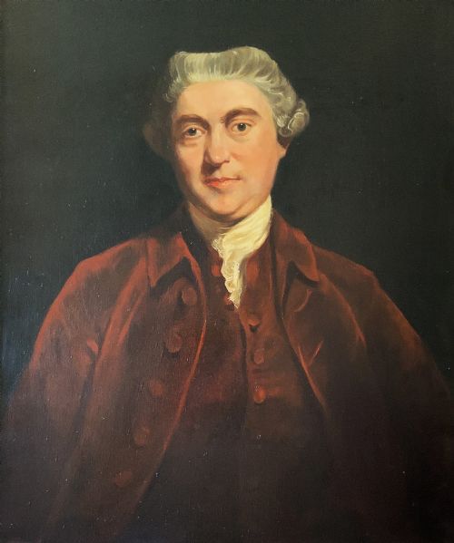 fig 3. An antique oil painting depicting a half-length portrait of a gentleman in a dark red coat, set within a carved gilded frame with a metal title plaque at the bottom.