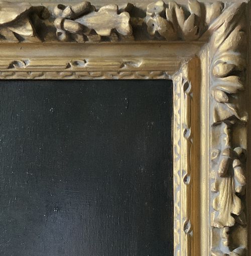 fig 9. An antique oil painting depicting a half-length portrait of a gentleman in a dark red coat, set within a carved gilded frame with a metal title plaque at the bottom.