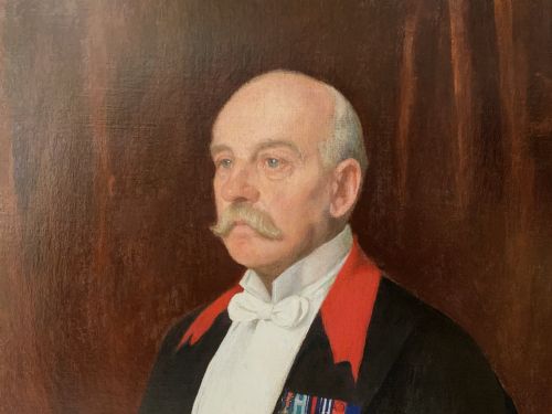 fig 5. An Edwardian portrait painting of a military officer wearing decorations and set within a carved gold frame.