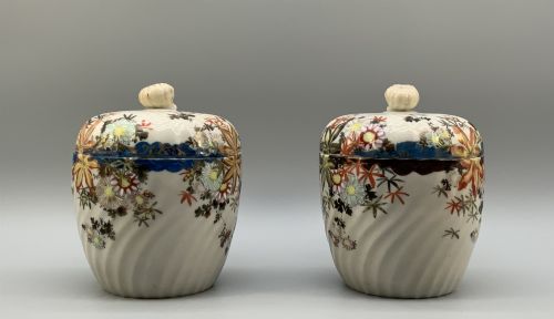fig 3. A pair of 19th-century Japanese cream porcelain lidded jars featuring spiralled fluted bodies and hand-painted polychrome floral decoration with sculpted finials.