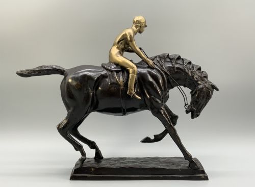 fig 8. A patinated bronze sculpture depicting a racehorse and jockey mid-stride set upon a textured rectangular bronze base.