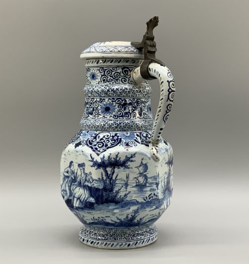 fig 2. An eighteenth-century blue and white Dutch Delftware ceramic jug decorated with hand-painted figures, complete with a fitted pewter lid.