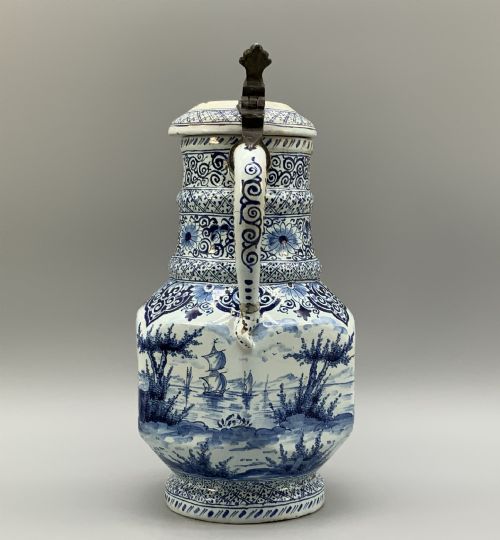 fig 3. An eighteenth-century blue and white Dutch Delftware ceramic jug decorated with hand-painted figures, complete with a fitted pewter lid.