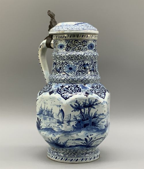 fig 5. An eighteenth-century blue and white Dutch Delftware ceramic jug decorated with hand-painted figures, complete with a fitted pewter lid.