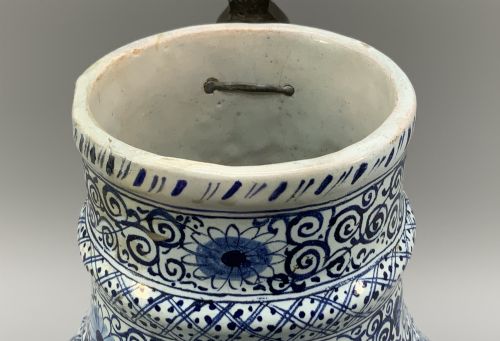 fig 8. An eighteenth-century blue and white Dutch Delftware ceramic jug decorated with hand-painted figures, complete with a fitted pewter lid.