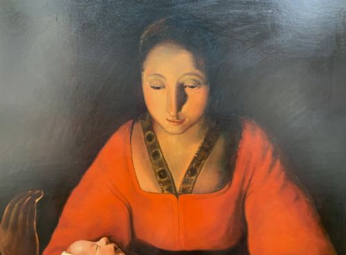 fig 8. A framed twentieth-century oil painting depicting two women in dramatic candlelight illumination leaning over a swaddled infant inside an ornate gold frame.