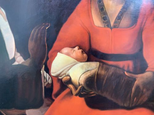 fig 9. A framed twentieth-century oil painting depicting two women in dramatic candlelight illumination leaning over a swaddled infant inside an ornate gold frame.
