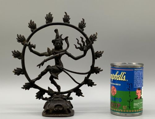 fig 2. A dark patinated bronze 19th-century figure of Shiva Nataraja dancing within a circular halo of flames atop a lotus pedestal.