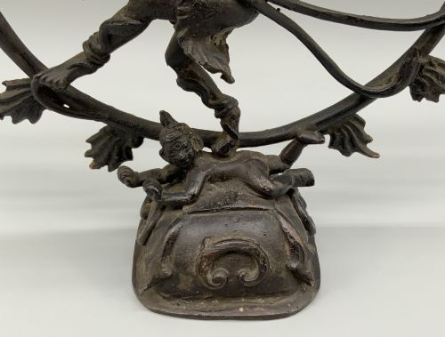 fig 4. A dark patinated bronze 19th-century figure of Shiva Nataraja dancing within a circular halo of flames atop a lotus pedestal.