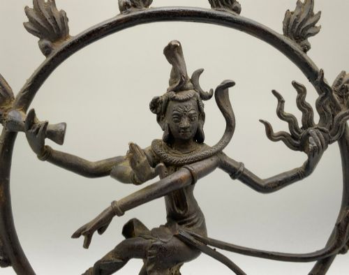 fig 5. A dark patinated bronze 19th-century figure of Shiva Nataraja dancing within a circular halo of flames atop a lotus pedestal.