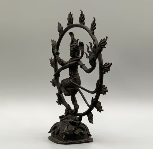 fig 6. A dark patinated bronze 19th-century figure of Shiva Nataraja dancing within a circular halo of flames atop a lotus pedestal.
