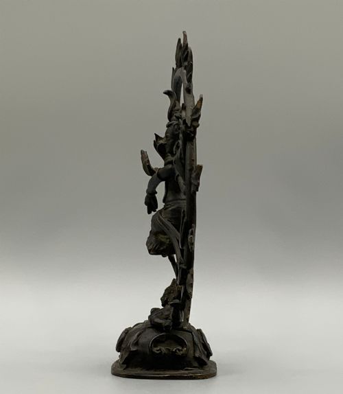 fig 7. A dark patinated bronze 19th-century figure of Shiva Nataraja dancing within a circular halo of flames atop a lotus pedestal.