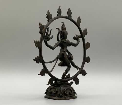 fig 8. A dark patinated bronze 19th-century figure of Shiva Nataraja dancing within a circular halo of flames atop a lotus pedestal.
