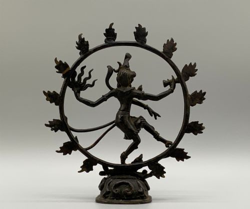 fig 9. A dark patinated bronze 19th-century figure of Shiva Nataraja dancing within a circular halo of flames atop a lotus pedestal.
