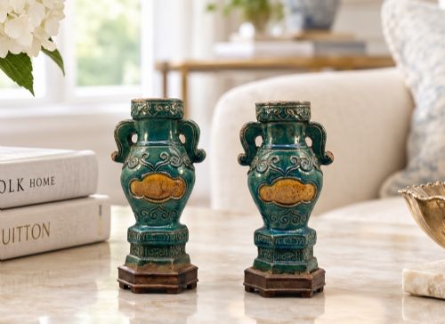 fig 1. A pair of early seventeenth-century Chinese ceramic vases featuring turquoise glaze, amber reserves, relief scrollwork, and wooden bases.
