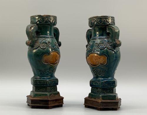 fig 2. A pair of early seventeenth-century Chinese ceramic vases featuring turquoise glaze, amber reserves, relief scrollwork, and wooden bases.