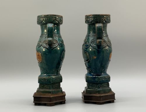 fig 5. A pair of early seventeenth-century Chinese ceramic vases featuring turquoise glaze, amber reserves, relief scrollwork, and wooden bases.