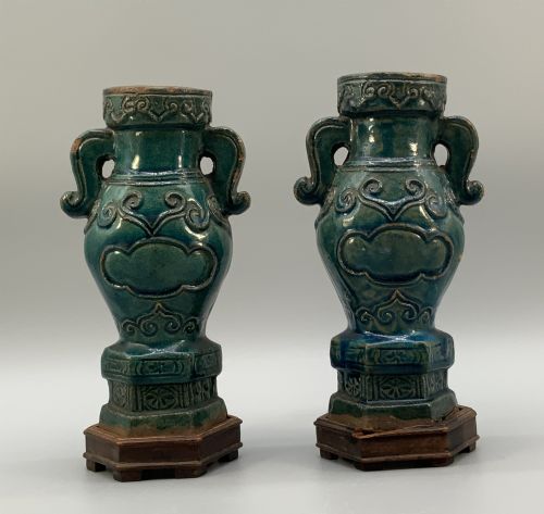 fig 6. A pair of early seventeenth-century Chinese ceramic vases featuring turquoise glaze, amber reserves, relief scrollwork, and wooden bases.