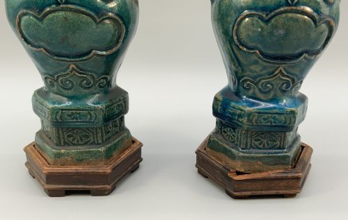 fig 7. A pair of early seventeenth-century Chinese ceramic vases featuring turquoise glaze, amber reserves, relief scrollwork, and wooden bases.