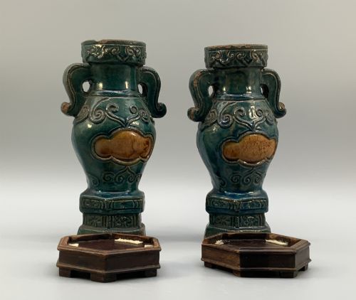 fig 8. A pair of early seventeenth-century Chinese ceramic vases featuring turquoise glaze, amber reserves, relief scrollwork, and wooden bases.
