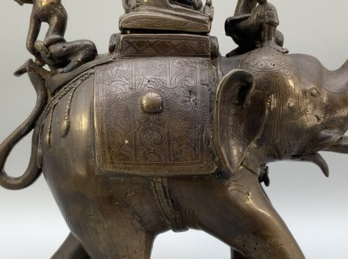 fig 8. A dark bronze 19th-century sculpture depicting an elephant with engraved decorative trappings and riders seated on its back.