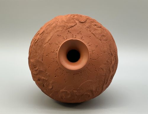 fig 8. A pair of unglazed terracotta red clay vases featuring detailed relief carvings of dragons with narrow flared necks.