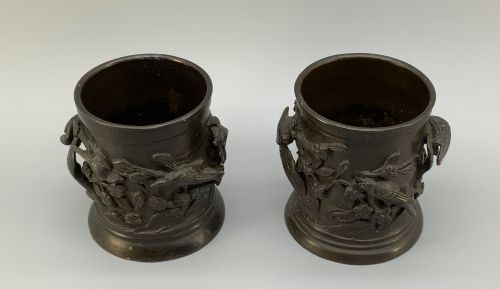 fig 3. A pair of cylindrical dark patinated bronze vases featuring raised relief depictions of birds perched amongst cherry blossom branches.