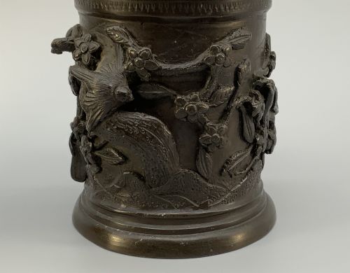 fig 7. A pair of cylindrical dark patinated bronze vases featuring raised relief depictions of birds perched amongst cherry blossom branches.