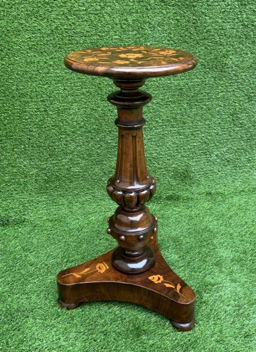 fig 1. A 19th-century Dutch marquetry wine table featuring a circular floral-inlaid top, a carved central column, and a shaped triform base raised on bun feet.