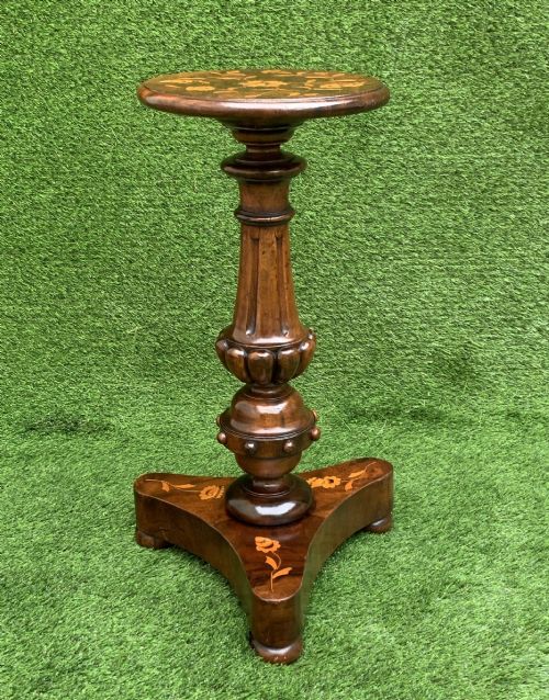 fig 2. A 19th-century Dutch marquetry wine table featuring a circular floral-inlaid top, a carved central column, and a shaped triform base raised on bun feet.