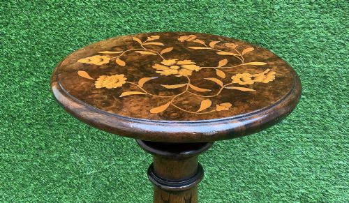 fig 4. A 19th-century Dutch marquetry wine table featuring a circular floral-inlaid top, a carved central column, and a shaped triform base raised on bun feet.