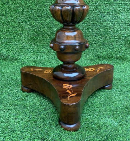 fig 6. A 19th-century Dutch marquetry wine table featuring a circular floral-inlaid top, a carved central column, and a shaped triform base raised on bun feet.