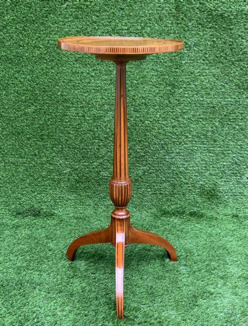 fig 2. A 19th-century satinwood wine table featuring a circular top with inlaid marquetry detailing, supported by a fluted central pedestal and three downswept tripod legs.