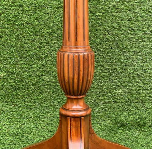 fig 6. A 19th-century satinwood wine table featuring a circular top with inlaid marquetry detailing, supported by a fluted central pedestal and three downswept tripod legs.