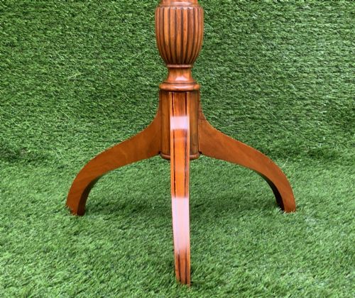 fig 7. A 19th-century satinwood wine table featuring a circular top with inlaid marquetry detailing, supported by a fluted central pedestal and three downswept tripod legs.